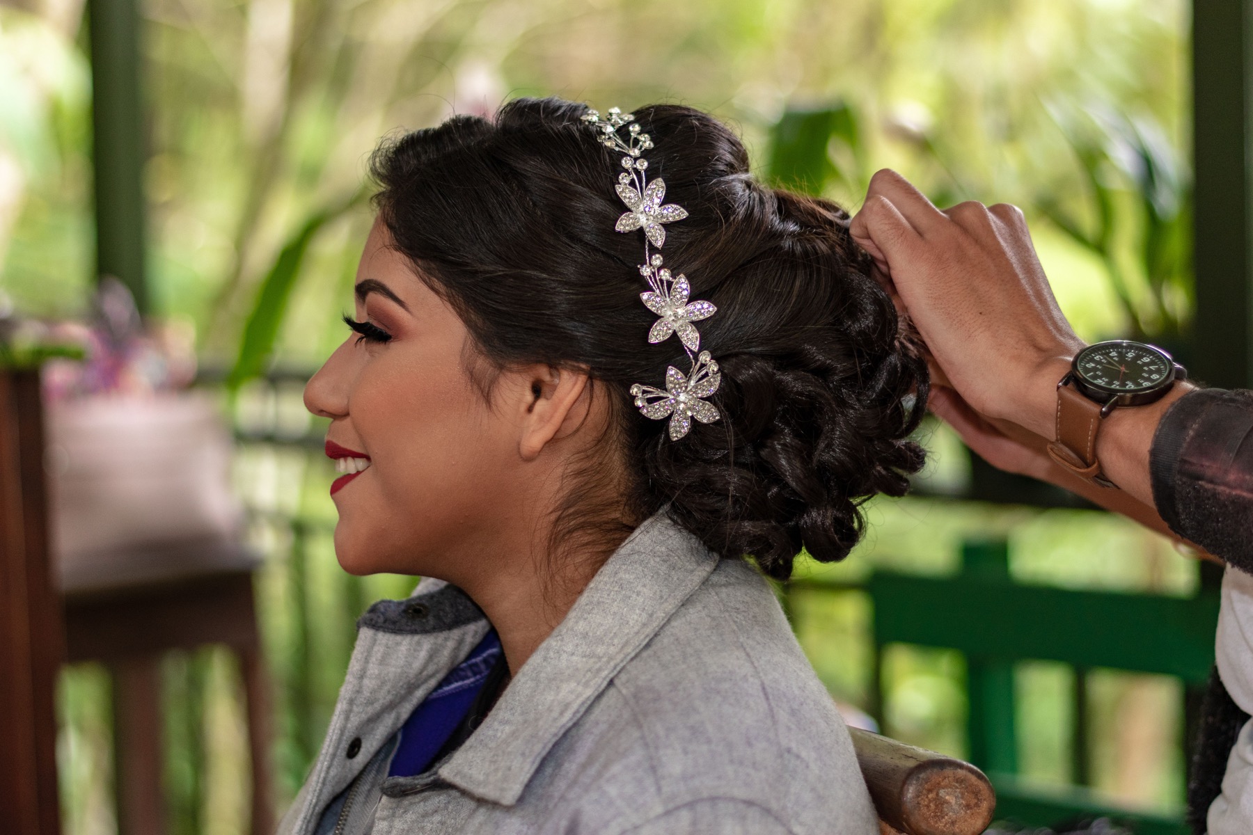 A hairstylist finishing an elegant updo
